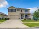 Two story house with tan exterior and brown shutters at 1927 Partin Terrace Rd, Kissimmee, FL 34744
