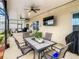Relaxing covered patio with seating area, dining table, and ceiling fans at 1927 Partin Terrace Rd, Kissimmee, FL 34744