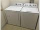 Laundry room with matching washer and dryer at 236 Paradise Woods Ct, Davenport, FL 33896