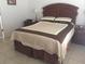 Comfortable bedroom with wooden bed frame and neutral bedding at 236 Paradise Woods Ct, Davenport, FL 33896
