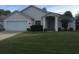 One-story house with attached garage and landscaped front yard at 236 Paradise Woods Ct, Davenport, FL 33896