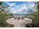 Community fire pit with seating overlooking a lake at 2601 Palisade Blvd, Kissimmee, FL 34741