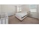 Bedroom with queen bed, dresser, and crib at 2601 Palisade Blvd, Kissimmee, FL 34741
