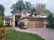 Two-story house with a brown garage door and landscaped yard at 325 Sonoma Valley Cir, Orlando, FL 32835