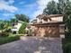 Two-story house with a brown garage door and landscaped yard at 325 Sonoma Valley Cir, Orlando, FL 32835
