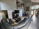 Large living area with sectional sofa, high ceilings, and staircase at 325 Sonoma Valley Cir, Orlando, FL 32835
