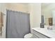 Clean bathroom with a shower/tub combo and gray shower curtain at 4963 Royal Point Ave, Kissimmee, FL 34746