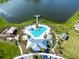 Community pool with a waterslide, adjacent to a lake and playground at 4963 Royal Point Ave, Kissimmee, FL 34746