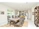 Dining room with rustic wood table and yellow chairs, adjacent to the kitchen at 4963 Royal Point Ave, Kissimmee, FL 34746