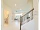 Bright living room with gray sectional sofa, staircase, and adjacent half bathroom at 4963 Royal Point Ave, Kissimmee, FL 34746