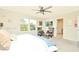 Spacious main bedroom with two armchairs and a large TV at 4963 Royal Point Ave, Kissimmee, FL 34746