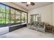 Relaxing screened porch with wicker furniture, offering a peaceful outdoor space at 540 Genoa Dr, Poinciana, FL 34759