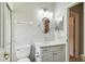 Clean bathroom with white vanity and oval mirror at 540 Genoa Dr, Poinciana, FL 34759