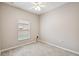 Simple bedroom with a window and neutral decor at 540 Genoa Dr, Poinciana, FL 34759