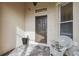 Inviting front entry with a wicker chair and potted plant at 540 Genoa Dr, Poinciana, FL 34759