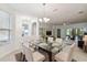 Elegant dining room featuring a glass table and modern chandelier at 540 Genoa Dr, Poinciana, FL 34759