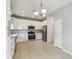 Modern kitchen with white shaker cabinets and stainless steel appliances at 540 Genoa Dr, Poinciana, FL 34759
