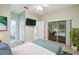 Primary bedroom with mirrored closet doors and ensuite bathroom at 540 Genoa Dr, Poinciana, FL 34759