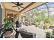 Large screened patio with seating area, grill, and lush landscaping at 561 Sienna Dr, Poinciana, FL 34759