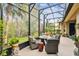 Relaxing screened patio with seating area and tranquil garden views at 561 Sienna Dr, Poinciana, FL 34759