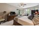 Main bedroom with TV and access to private balcony at 561 Sienna Dr, Poinciana, FL 34759