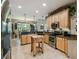 Spacious kitchen with granite countertops, stainless steel appliances, and light wood cabinets at 561 Sienna Dr, Poinciana, FL 34759
