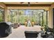Spacious covered patio with seating, grill, and tranquil fountain at 561 Sienna Dr, Poinciana, FL 34759