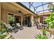 Spacious screened patio with comfortable seating and lush landscaping at 561 Sienna Dr, Poinciana, FL 34759