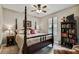 Large bedroom with a king-size bed and built-in shelving at 561 Sienna Dr, Poinciana, FL 34759