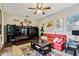 Gathering room with a large TV, comfortable seating, and movie posters at 561 Sienna Dr, Poinciana, FL 34759