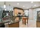 Large kitchen with granite countertops, island, and stainless steel appliances at 561 Sienna Dr, Poinciana, FL 34759