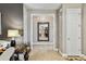 Bright hallway with tile floors and large mirror reflecting a dining area at 561 Sienna Dr, Poinciana, FL 34759
