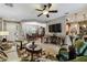 Spacious living area with hardwood floors, comfortable furniture, and a view into the kitchen and dining area at 561 Sienna Dr, Poinciana, FL 34759