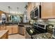 Kitchen features granite countertops, stainless steel appliances, and light wood cabinets at 561 Sienna Dr, Poinciana, FL 34759