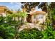 Inviting front yard with lush landscaping and a fountain at 561 Sienna Dr, Poinciana, FL 34759