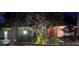 Night view of house exterior with landscaping and lighting at 561 Sienna Dr, Poinciana, FL 34759