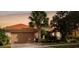 Beautiful home exterior with a two-car garage and landscaping at 561 Sienna Dr, Poinciana, FL 34759