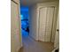 Hallway view of bedroom with white doors and carpet flooring at 660 Celebration Ave # 260, Kissimmee, FL 34747