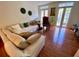 Living room with beige sectional sofa and hardwood floors at 660 Celebration Ave # 260, Kissimmee, FL 34747