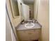 Small bathroom with granite countertop, white cabinets, and a mirrored medicine cabinet at 660 Celebration Ave # 260, Kissimmee, FL 34747