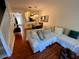 Living room with hardwood floors, sectional sofa, and view into dining area and kitchen at 660 Celebration Ave # 260, Kissimmee, FL 34747