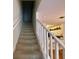 Carpeted staircase with white railings leading to the upper level at 660 Celebration Ave # 260, Kissimmee, FL 34747