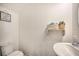 Small bathroom with a sink, toilet and shelf at 709 Benoi Dr, Davenport, FL 33896