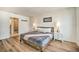Main bedroom with a queen-size bed, hardwood floors, and an ensuite bath at 709 Benoi Dr, Davenport, FL 33896