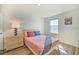 Bright bedroom with a double bed and light wood dresser at 709 Benoi Dr, Davenport, FL 33896