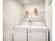 Laundry room with washer and dryer, shelving for storage at 709 Benoi Dr, Davenport, FL 33896