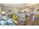 Open concept living and kitchen area with hardwood floors and natural light at 709 Benoi Dr, Davenport, FL 33896