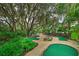 Community mini golf course surrounded by lush landscaping at 709 Benoi Dr, Davenport, FL 33896