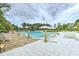 Community pool with lounge chairs and umbrellas at 709 Benoi Dr, Davenport, FL 33896