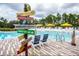 Community pool with lounge chairs and a distance marker at 709 Benoi Dr, Davenport, FL 33896
